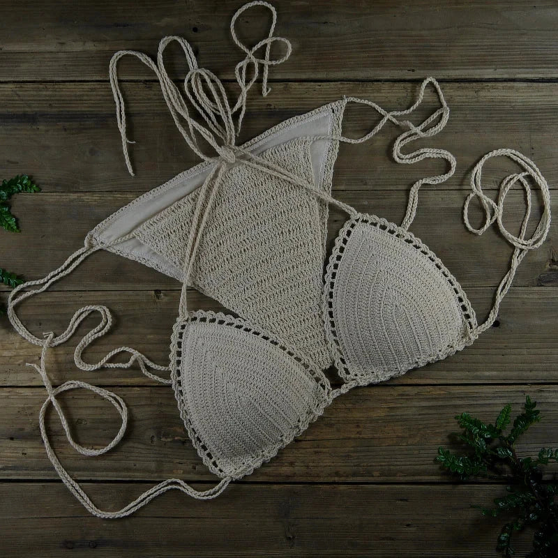 Handmade crochet bikini set with push up top and triangle neckline on wooden surface, women's swimwear.
